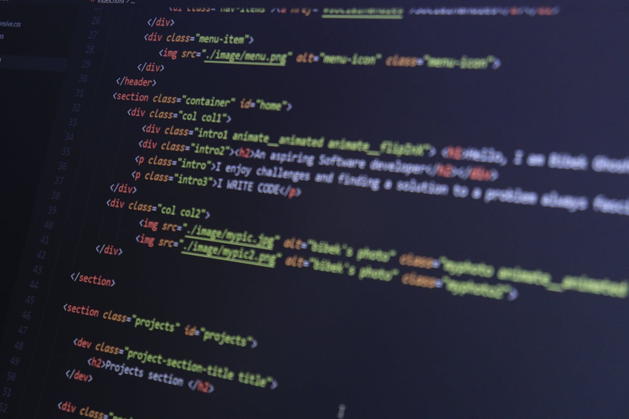heros-img HTML and CSS code on a computer monitor, highlighting web development and programming.